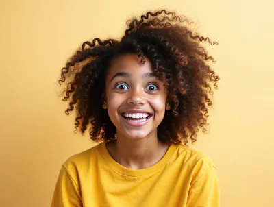 Excited Young Girl With Curly Hair Smiling
