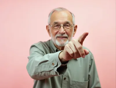 Senior Man Pointing Forward At Camera