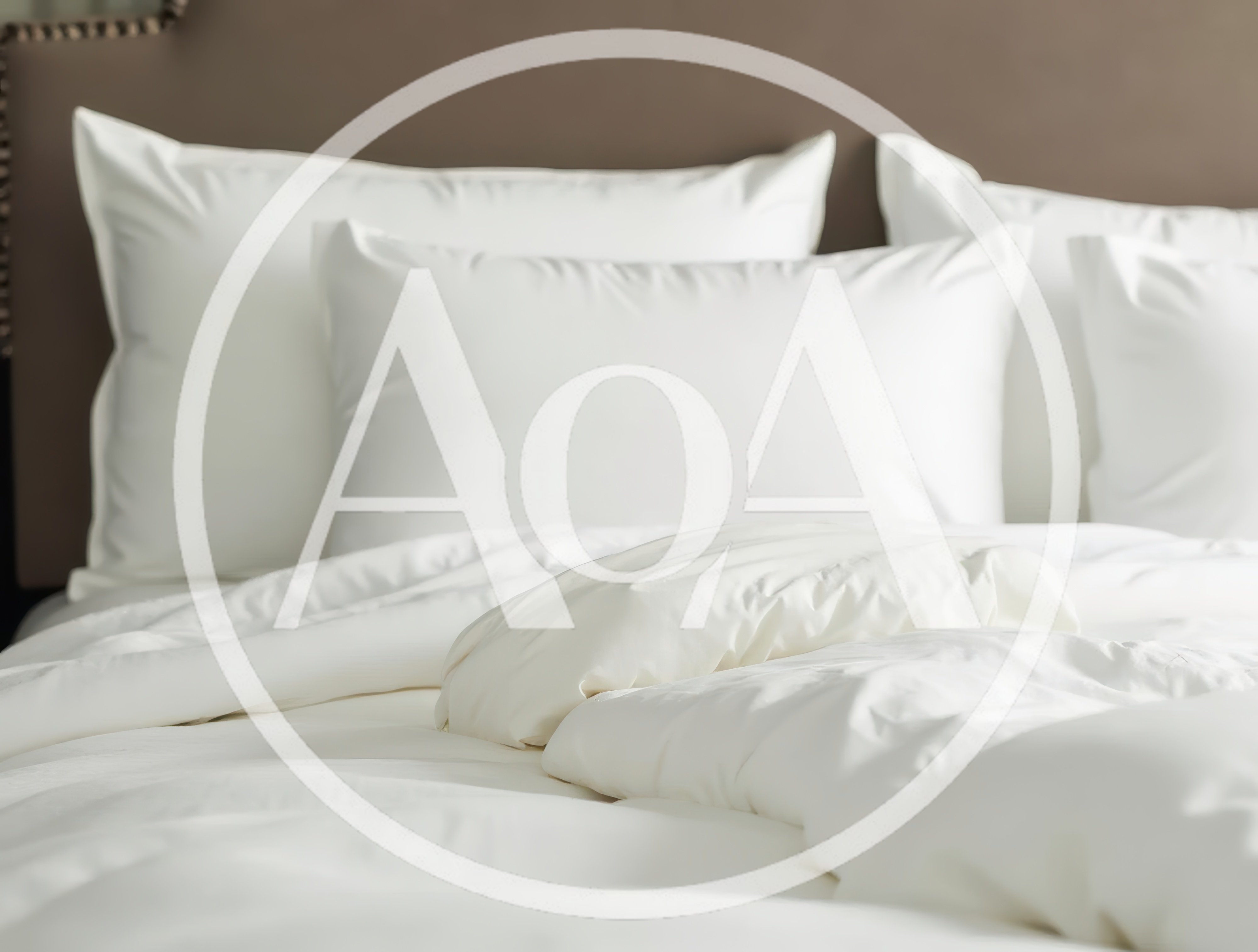 White Bedding With Fluffy Pillows On A Bed