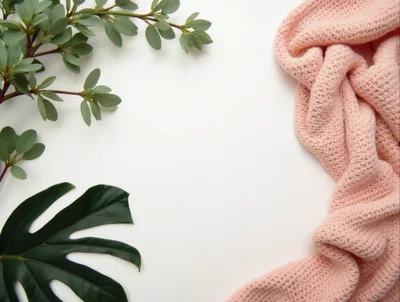Flat Lay Composition With Pink Knit Fabric And Green Leaves