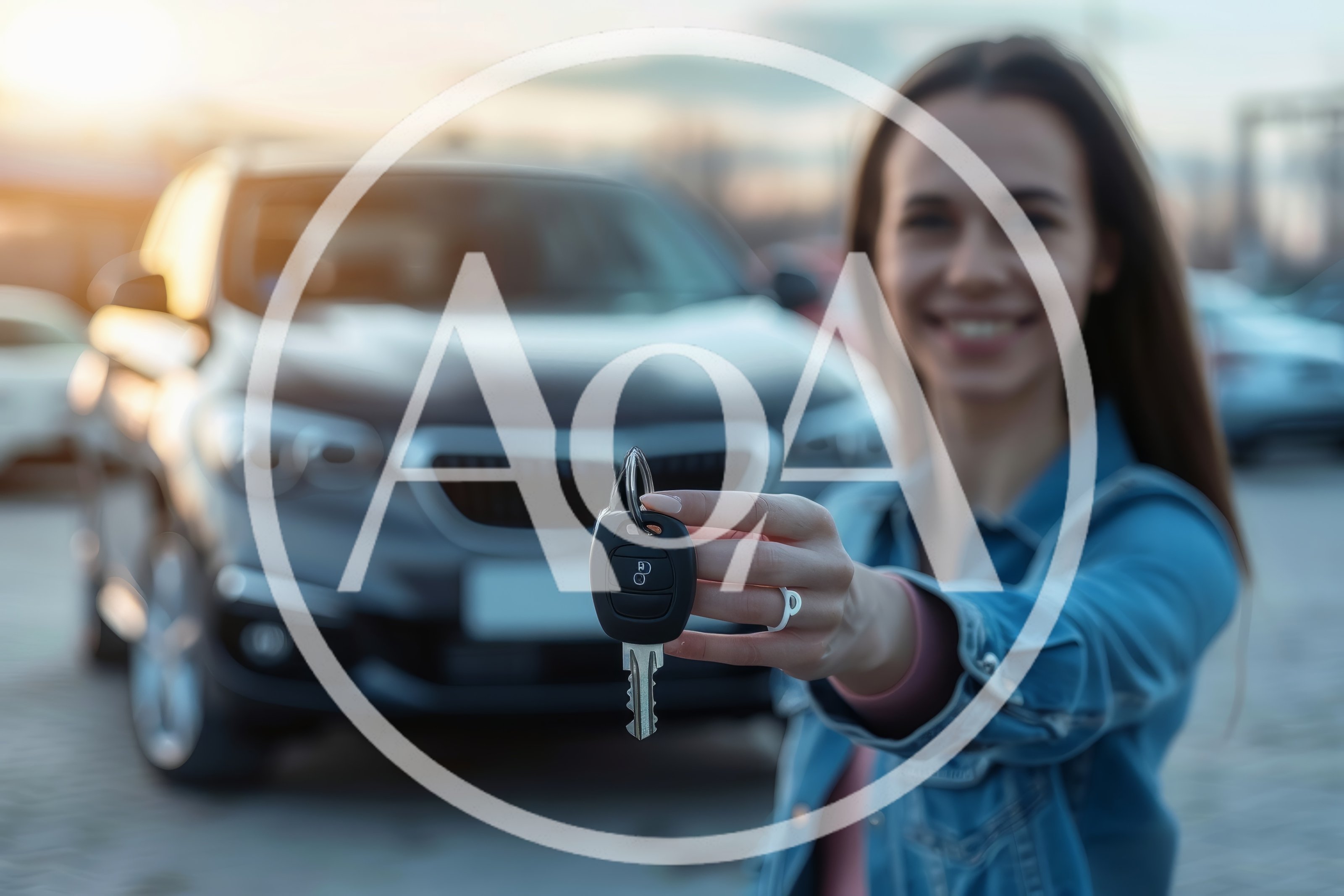 Young Woman Holding Car Keys In Front Of Vehicle