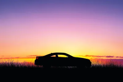 Silhouette Of A Sports Car At Sunset