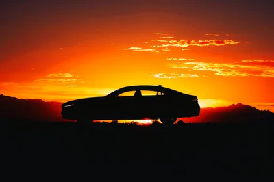 Silhouette Of A Luxury Sedan At Sunset