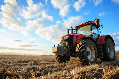 Red Tractor Parked In A Harvested Field