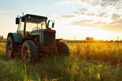 Old Rusty Tractor Parked In A Golden Field