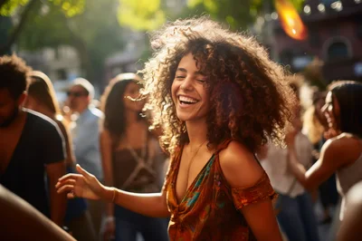 Young Woman Dancing Joyfully at an Outdoor Street Festival