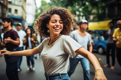 Happy Young Woman Dancing Joyfully In City Street