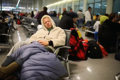 Traveler Sleeping in Airport Terminal Waiting Area