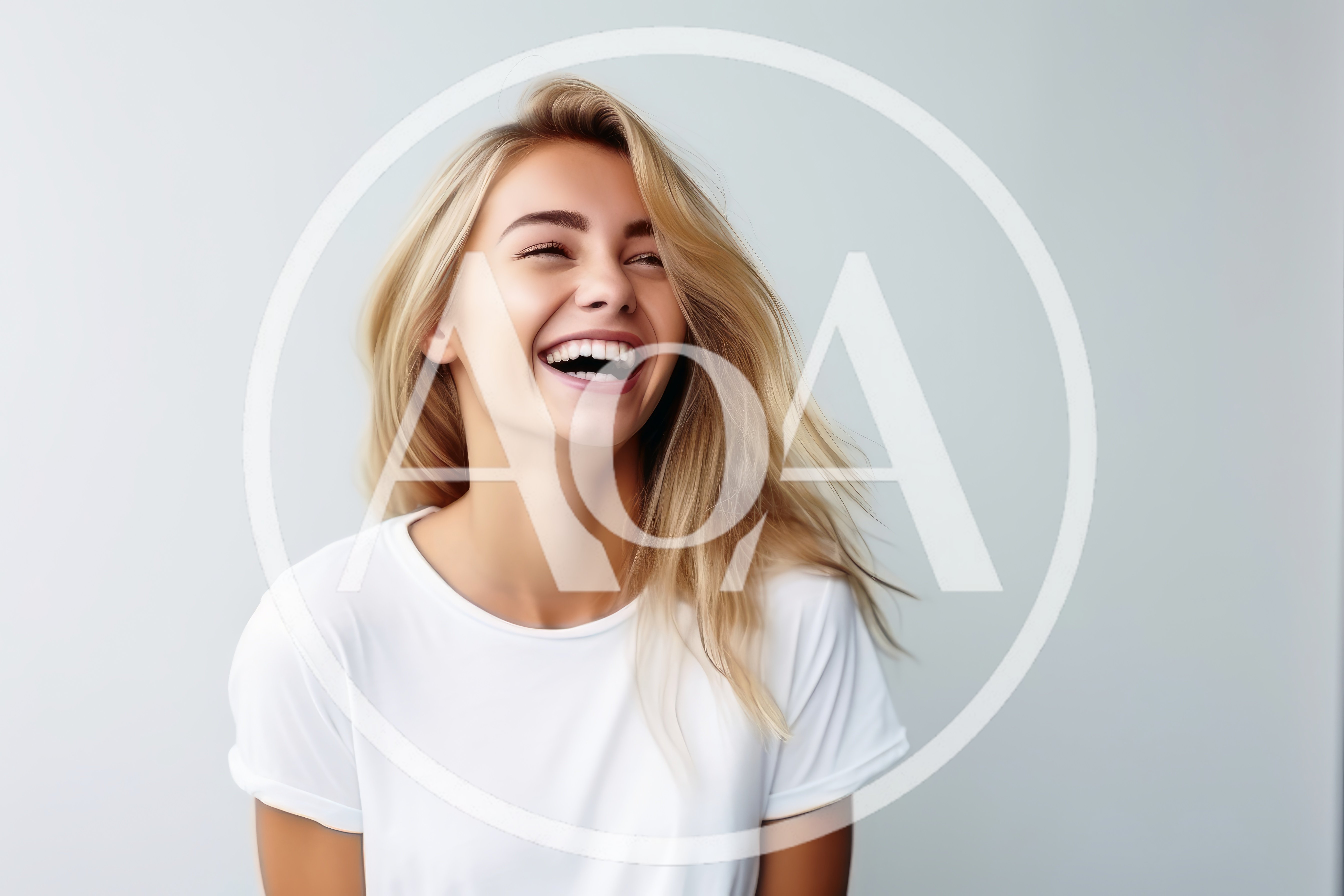 Happy Young Woman Laughing Against A Plain Background
