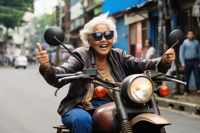 Elderly Woman Riding A Motorcycle Giving A Thumbs Up