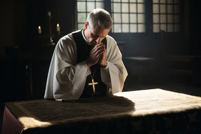 Priest Praying At An Altar In A Dimly Lit Church