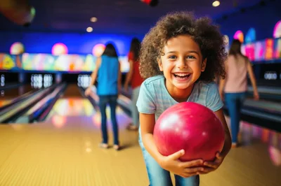 Happy Young Girl Holding Bowling Ball