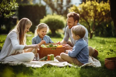 Happy Family Having A Picnic In A Sunny Park