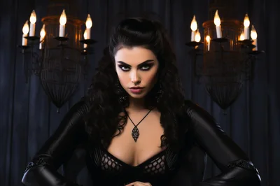 Gothic Woman With Dark Makeup In A Candlelit Room