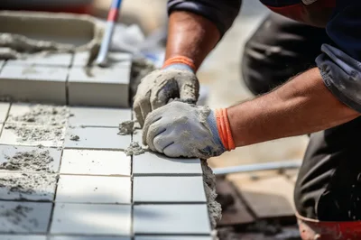 Construction Worker Laying Ceramic Tiles With Mortar