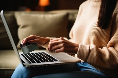 Woman Shopping Online With Credit Card On Laptop