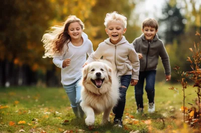 Three Children Running With A Dog In Autumn Park