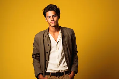 Young Man Posing In Casual Jacket Against Yellow Background