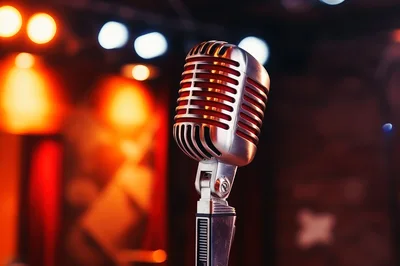 Vintage Silver Microphone On Stage Under Warm Lighting