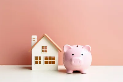 Miniature House Model and Pink Piggy Bank