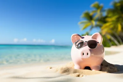 Pink Piggy Bank Wearing Sunglasses On Tropical Beach