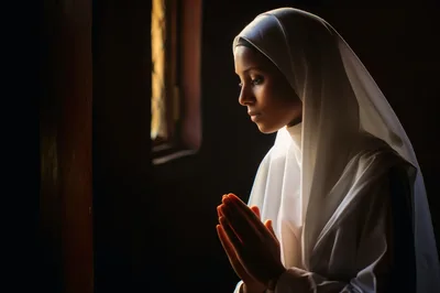 Young Woman In White Hijab Praying In Dim Light