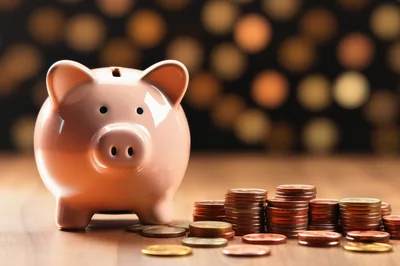 Pink Piggy Bank With Stacks Of Coins