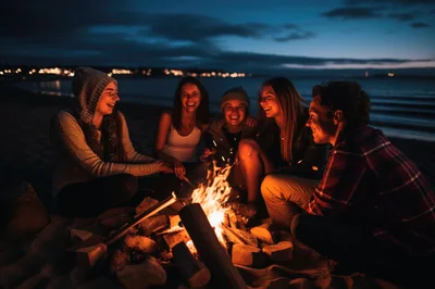 Friends Enjoying A Beach Bonfire At Twilight