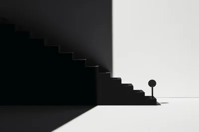 Minimalist Black Staircase Against A Stark White Wall