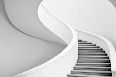 Minimalist Curved Staircase In Modern White Interior