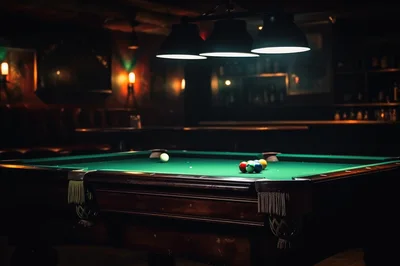Billiard Table With Pool Balls In Dimly Lit Bar
