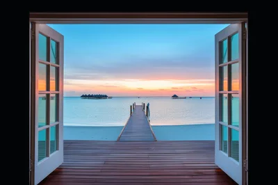 Open Doorway View Of Tropical Sunset Over Ocean Pier