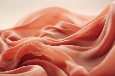Abstract Flowing Peach Silk Fabric Background