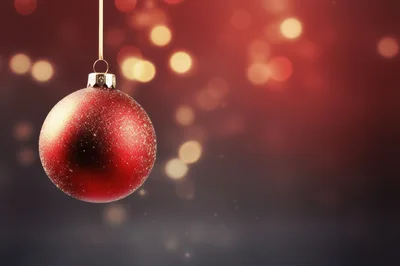 Red Glittery Christmas Ornament Hanging Against Bokeh Background
