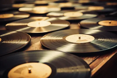 Collection Of Vintage Vinyl Records On Wooden Surface