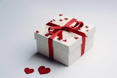 White Gift Box With Red Ribbon And Heart Decorations