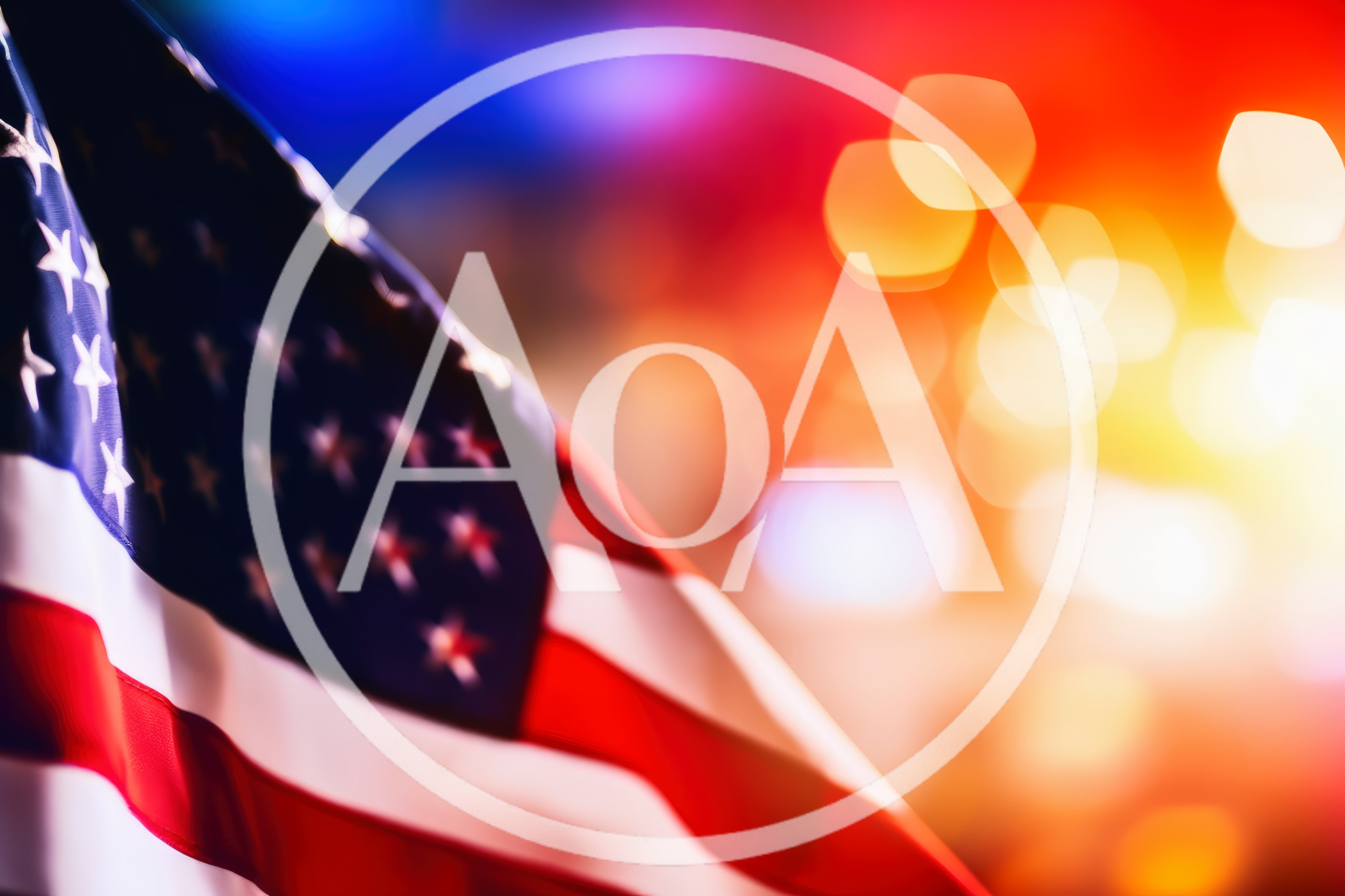 American Flag Waving Against Blurred Emergency Lights