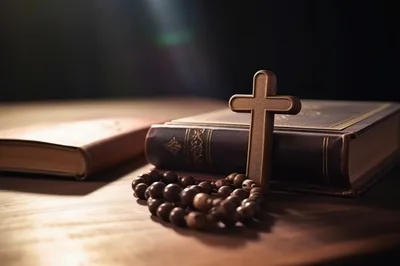Wooden Cross And Rosary Beads Resting On Holy Bible