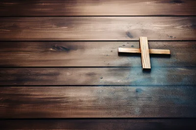 Wooden Cross Resting On A Dark Rustic Wooden Surface