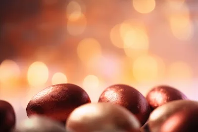 Metallic Red Easter Eggs With Bokeh Background