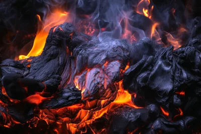 Burning Charcoal Embers With Intense Flames And Smoke
