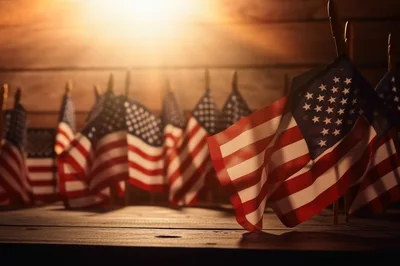 Small American Flags Arranged on Wooden Surface