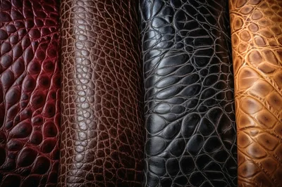 Four Rolls Of Textured Exotic Leather In Different Colors