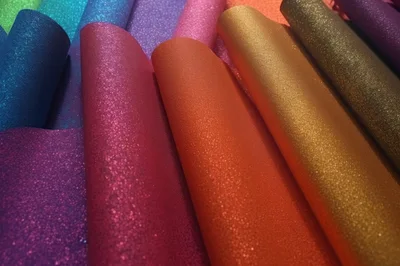 Colorful Glitter Fabric Rolls Arranged In Rows