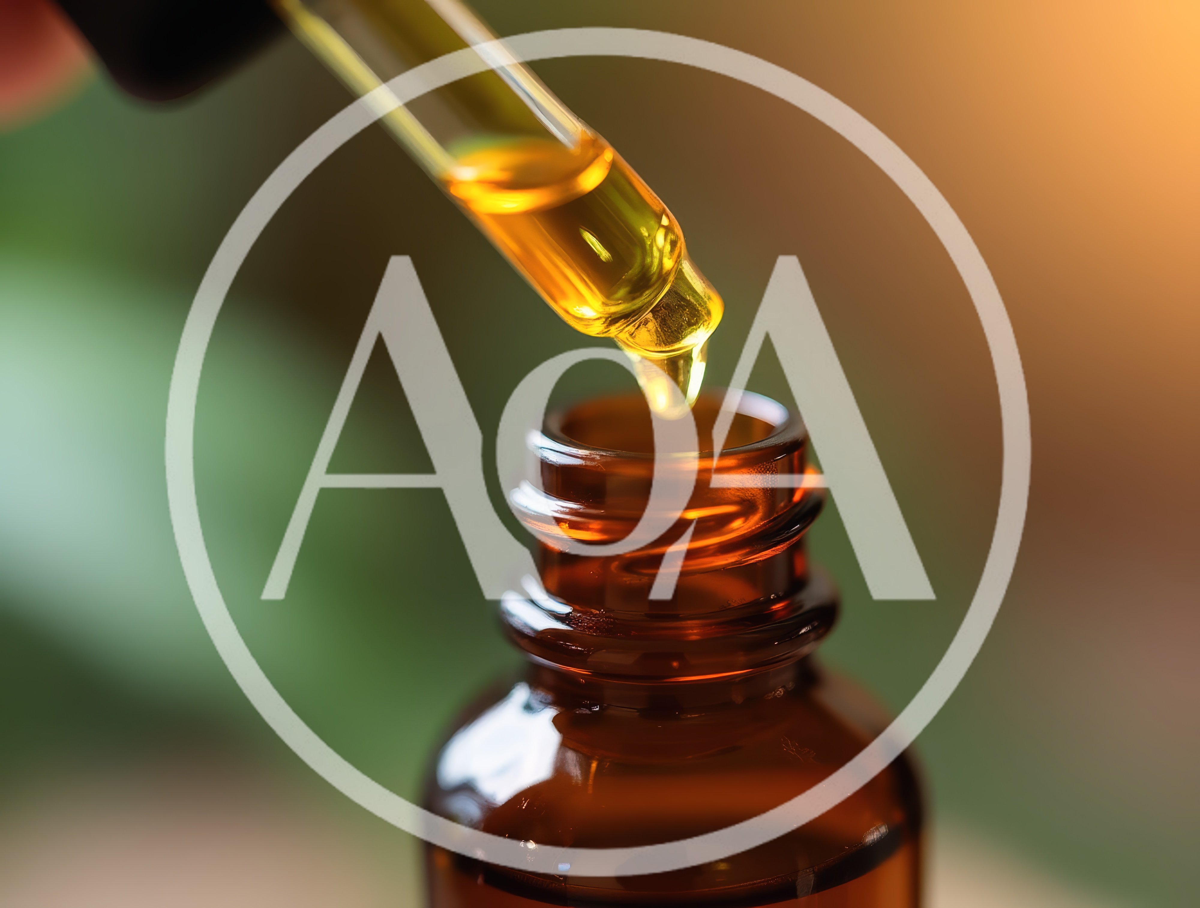 Dropper Dispensing Golden Essential Oil Into Amber Bottle