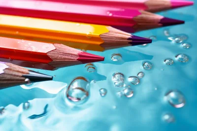 Colored Pencils Submerged In Clear Blue Water