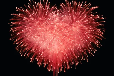 Heart Shaped Red Fireworks Display Against Black Sky