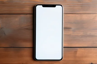 Modern Smartphone With Blank Screen On Wooden Table