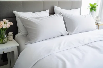 Modern Bedroom Interior With White Bedding And Flowers
