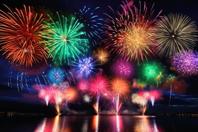 Vibrant Multi-Colored Fireworks Display Over Calm Water